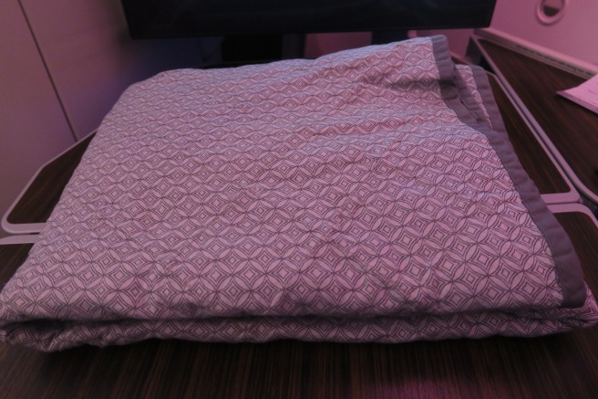 a pink blanket on a table