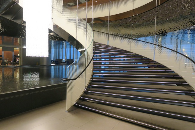 a spiral staircase with a glass wall