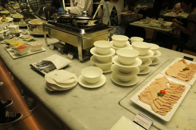 a buffet table with plates and bowls