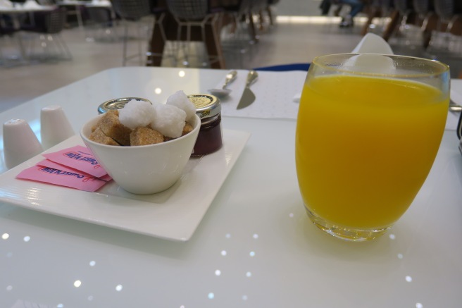 a plate of food and a glass of orange juice