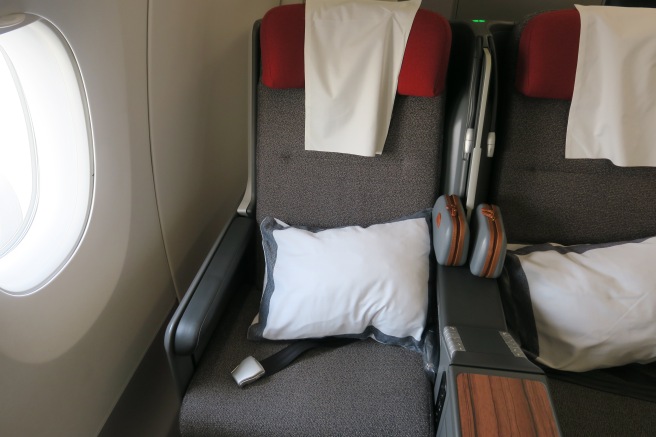 a seat with pillows and a pillow on it