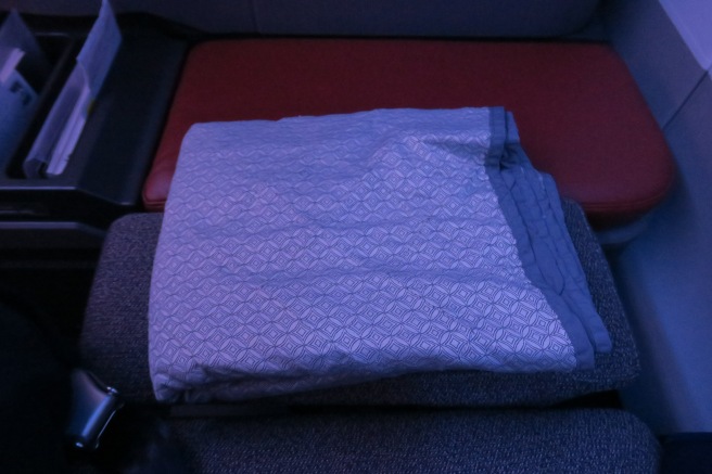 a folded blanket on a seat