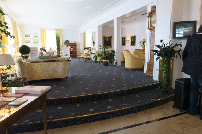 a lobby with a reception desk and stairs