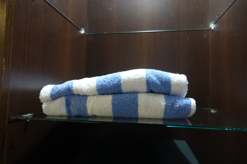 a stack of towels on a glass shelf