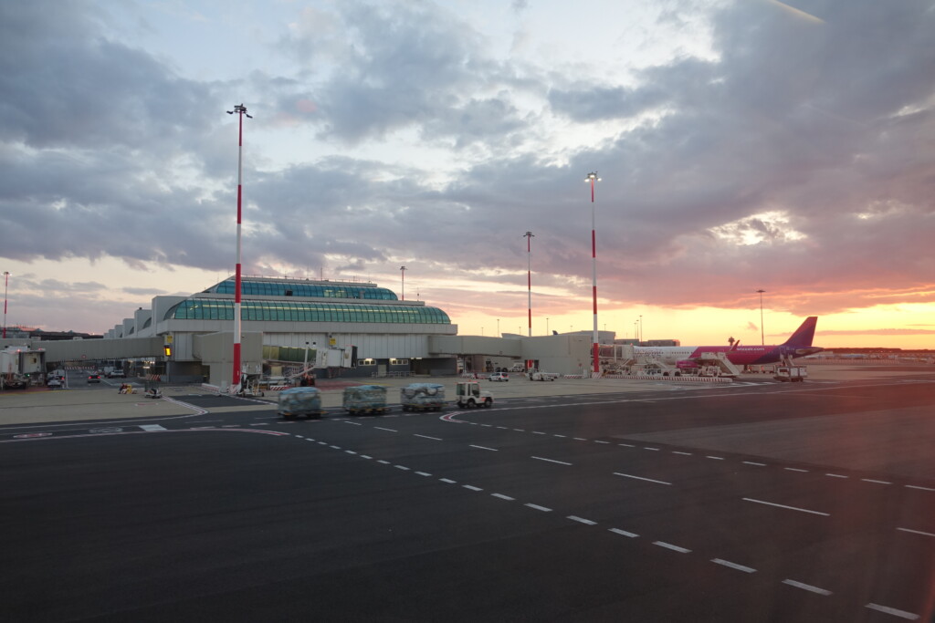 a large airport with a building and a runway