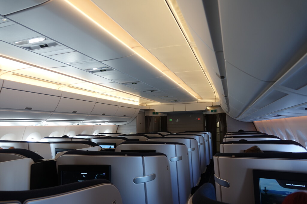 an airplane with seats and a light on the ceiling
