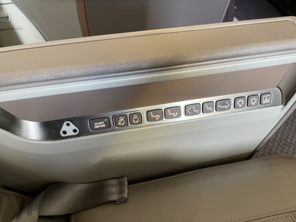 a seat with buttons and lights on it