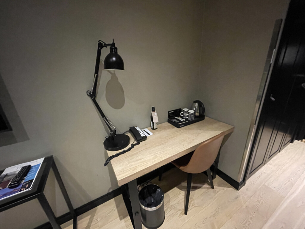 a desk with a lamp and a telephone