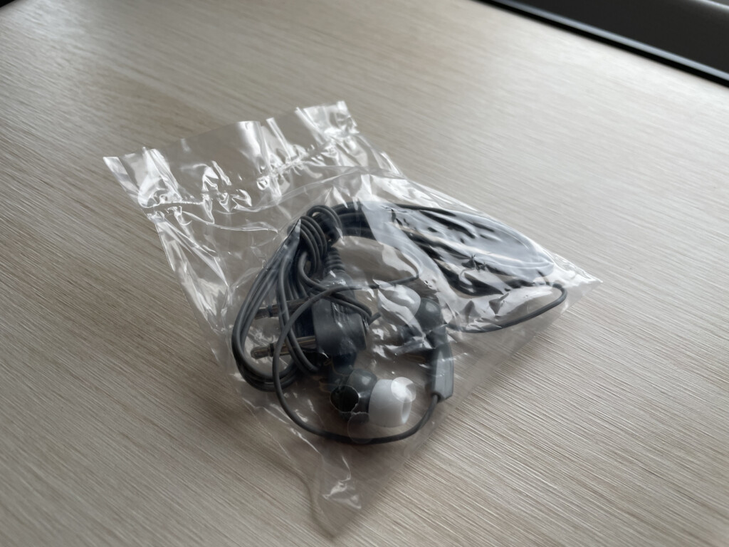 a plastic bag with earbuds on it