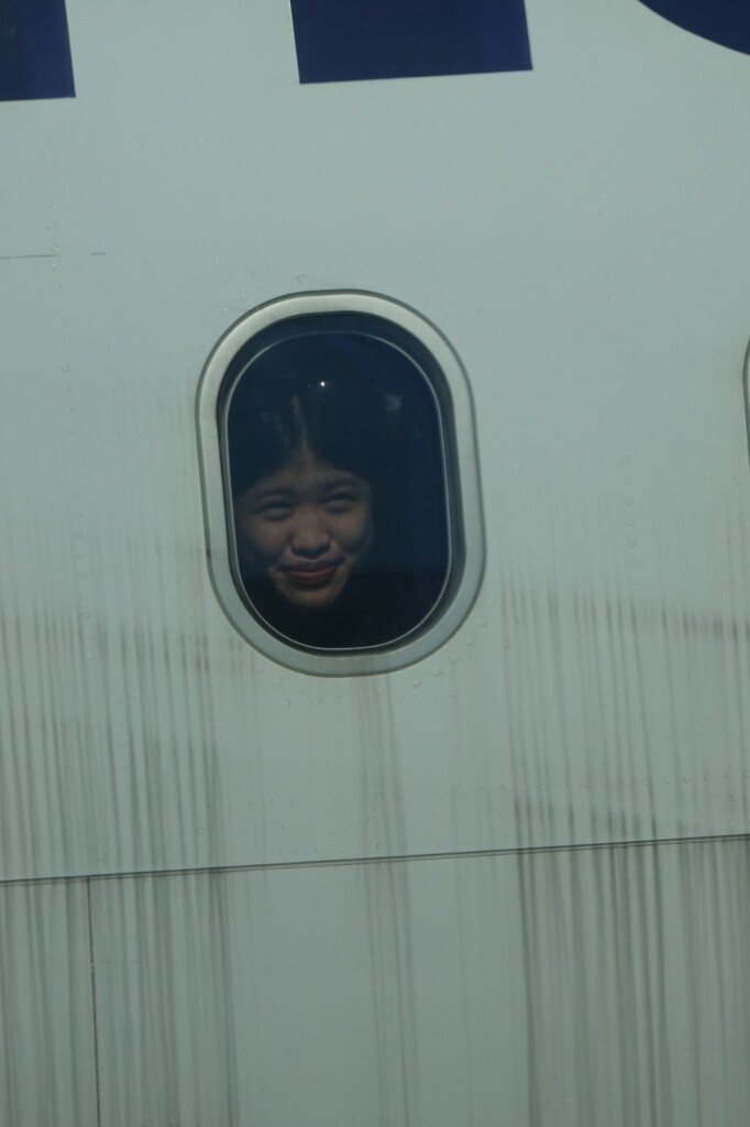 a girl looking through a window
