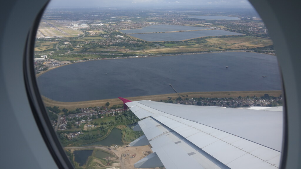 an airplane wing over a body of water