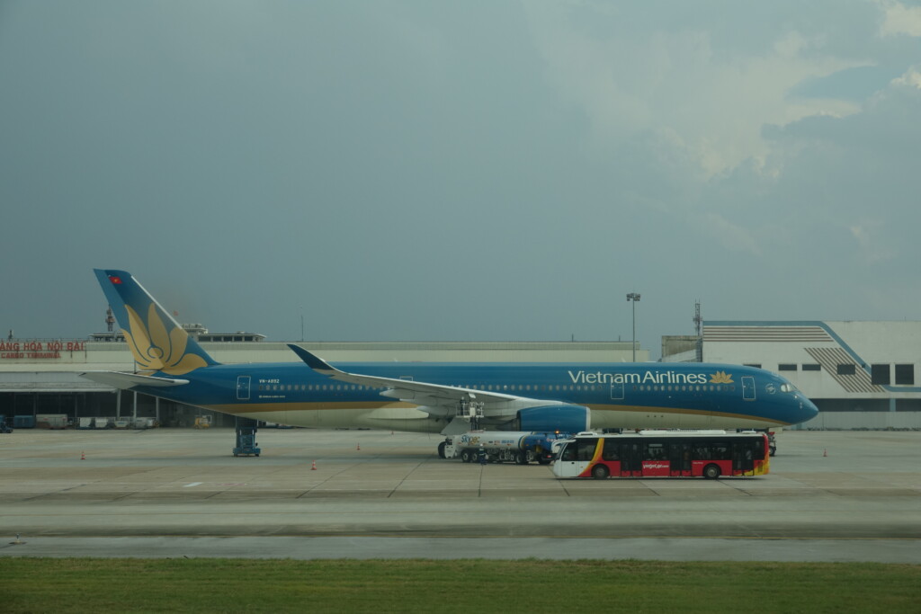 a blue and yellow airplane on a tarmac