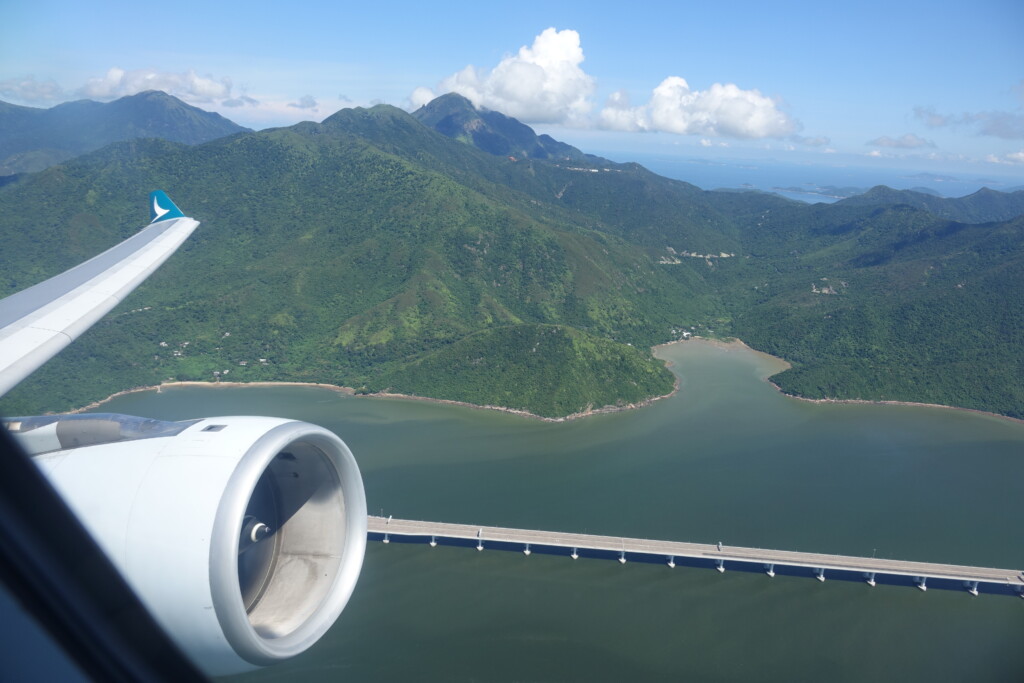 a view of a bridge and mountains from an airplane