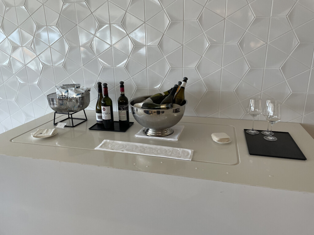 a bowl of wine and wine glasses on a counter