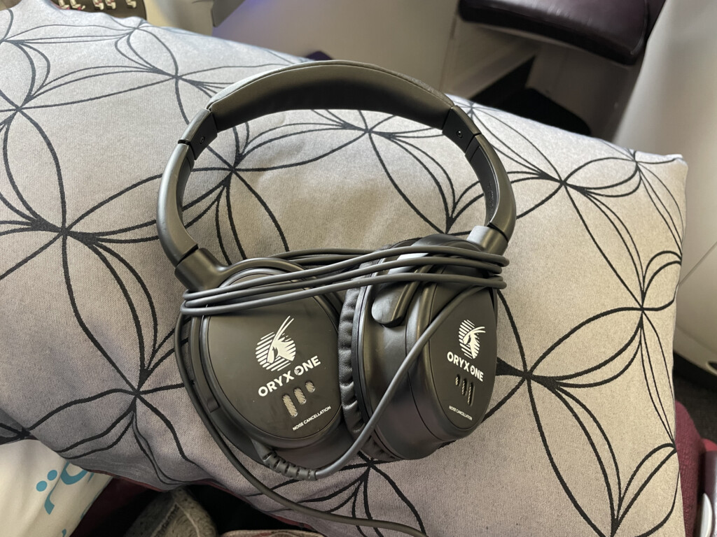 a pair of black headphones on a patterned surface