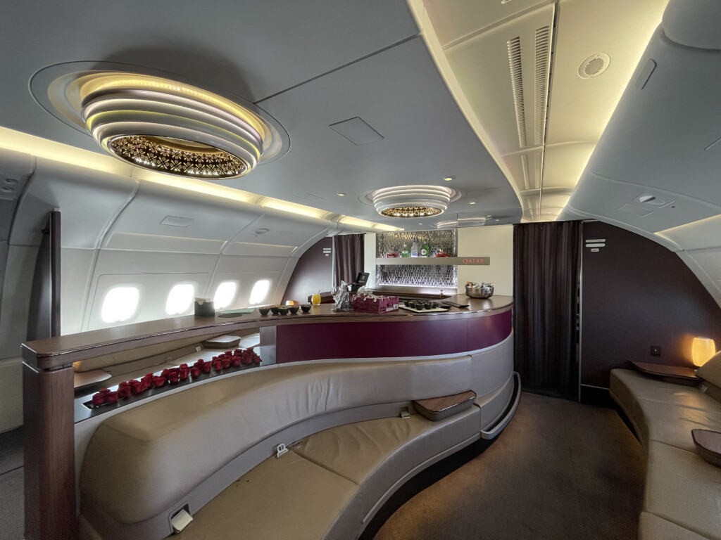 a interior of an airplane with a bar and chairs