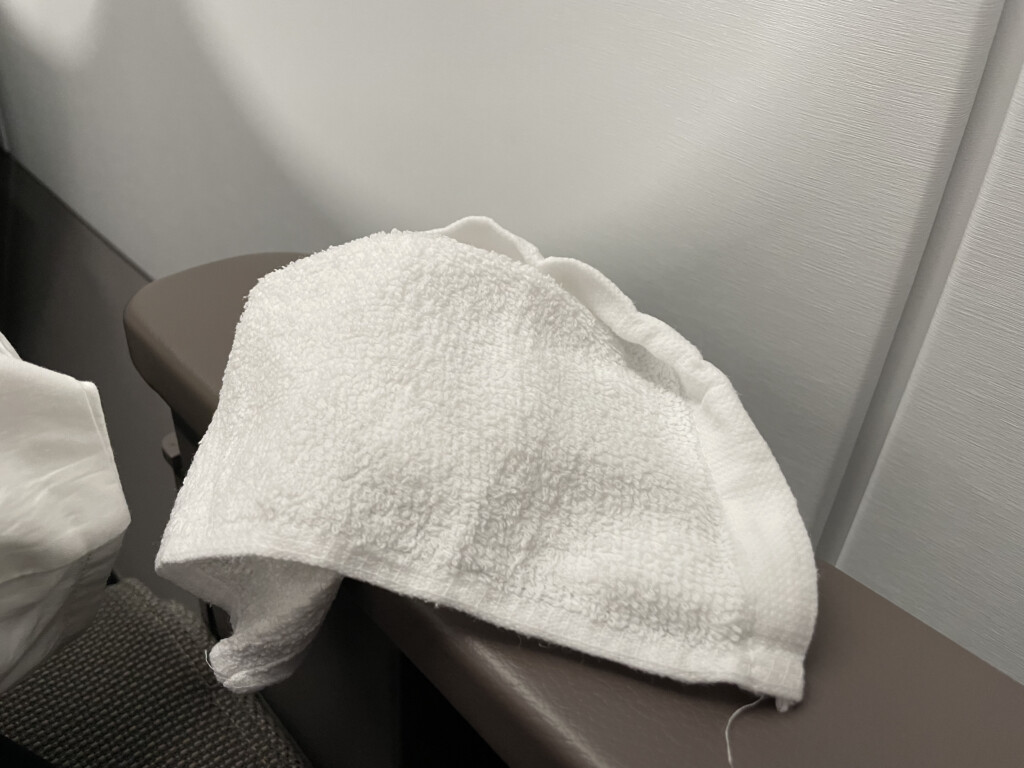 a white towel on a brown surface