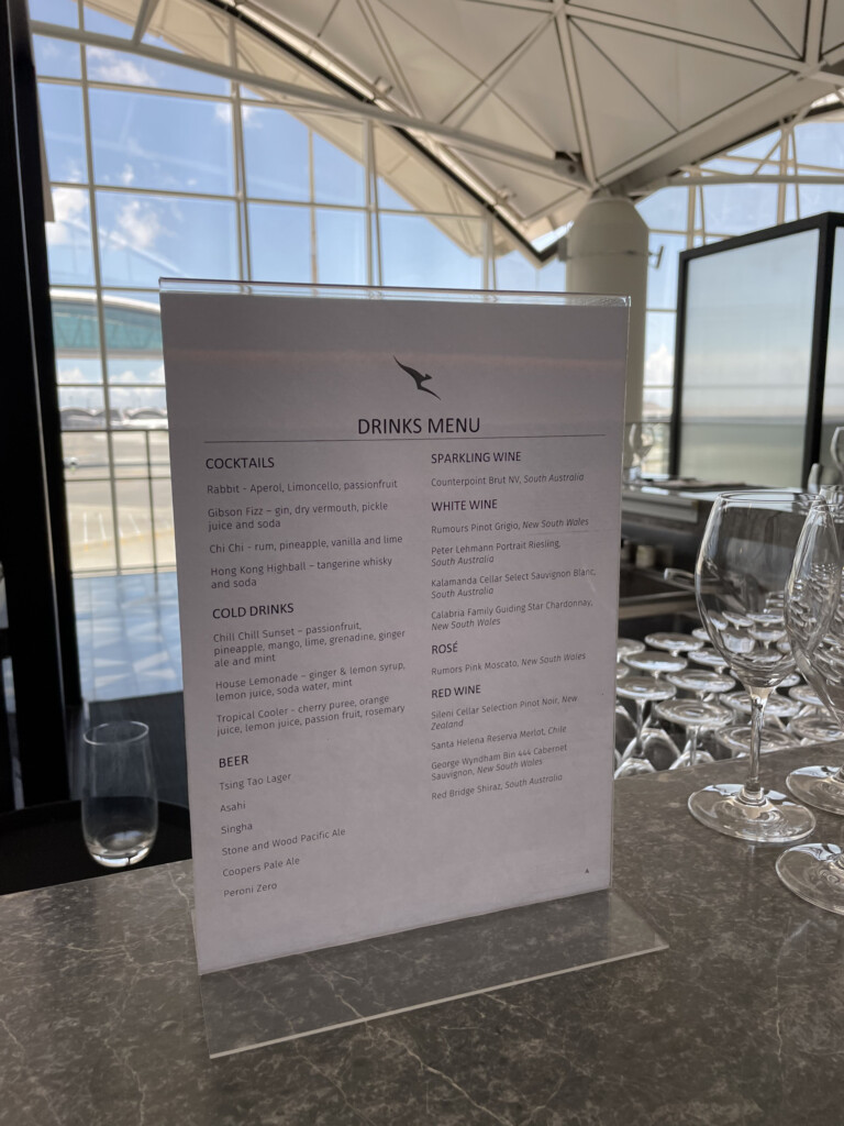 a menu on a table with wine glasses