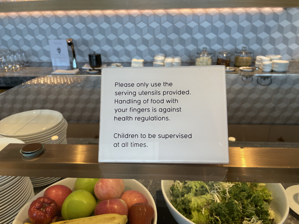 a sign on a shelf with food in bowls