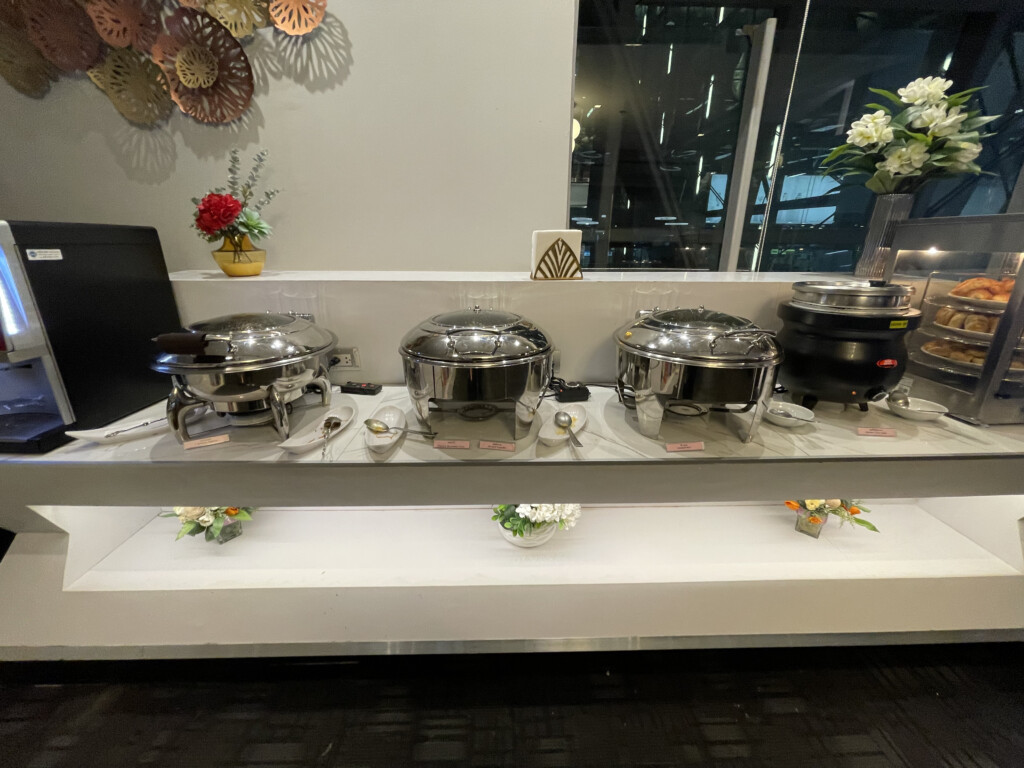a group of silver pots on a shelf