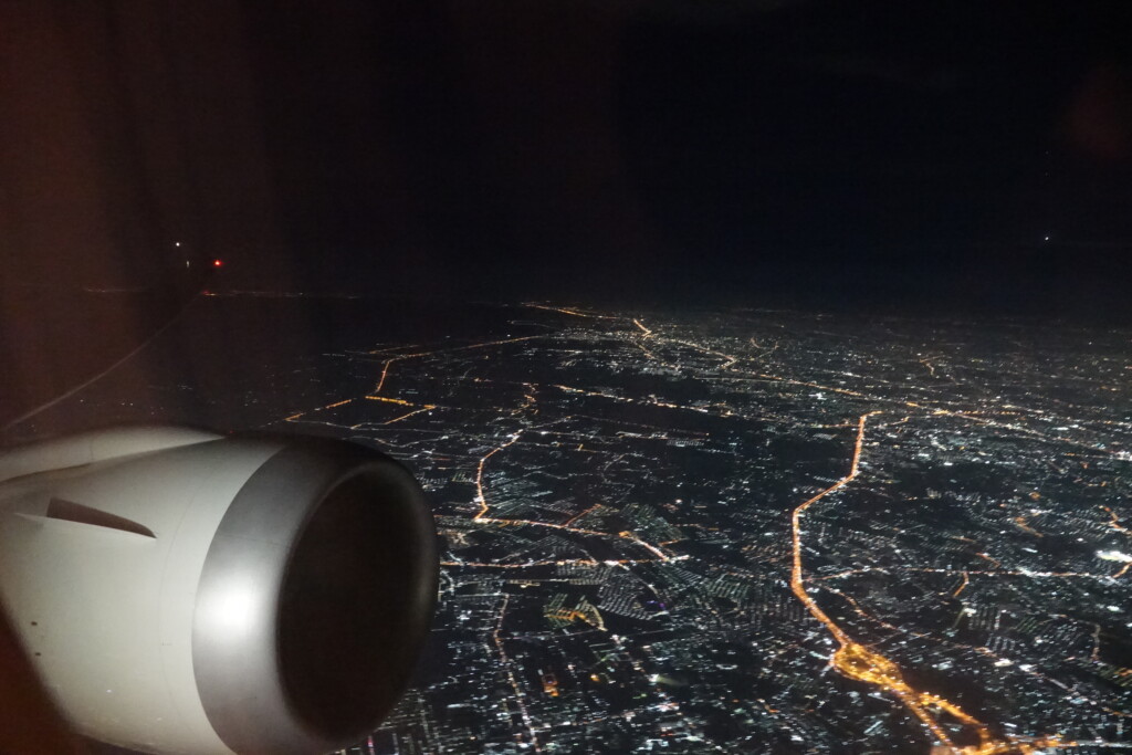 an airplane wing with a city at night