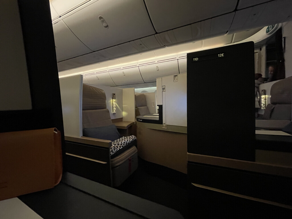 an airplane with a bed and a chair
