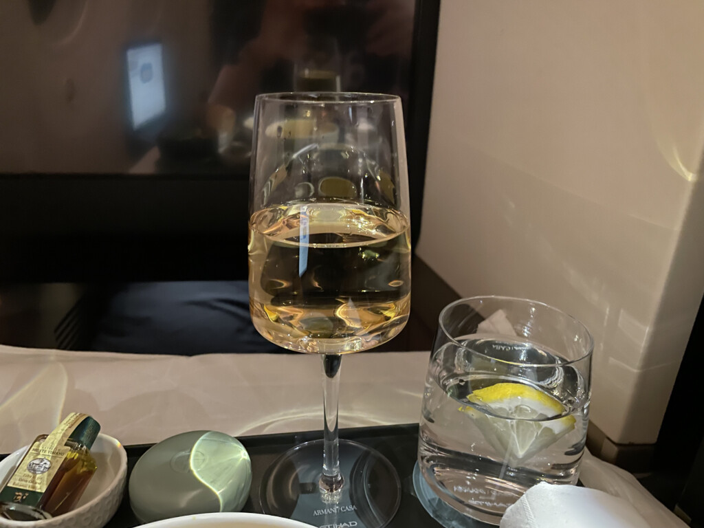 a glass of wine and a glass of water on a tray