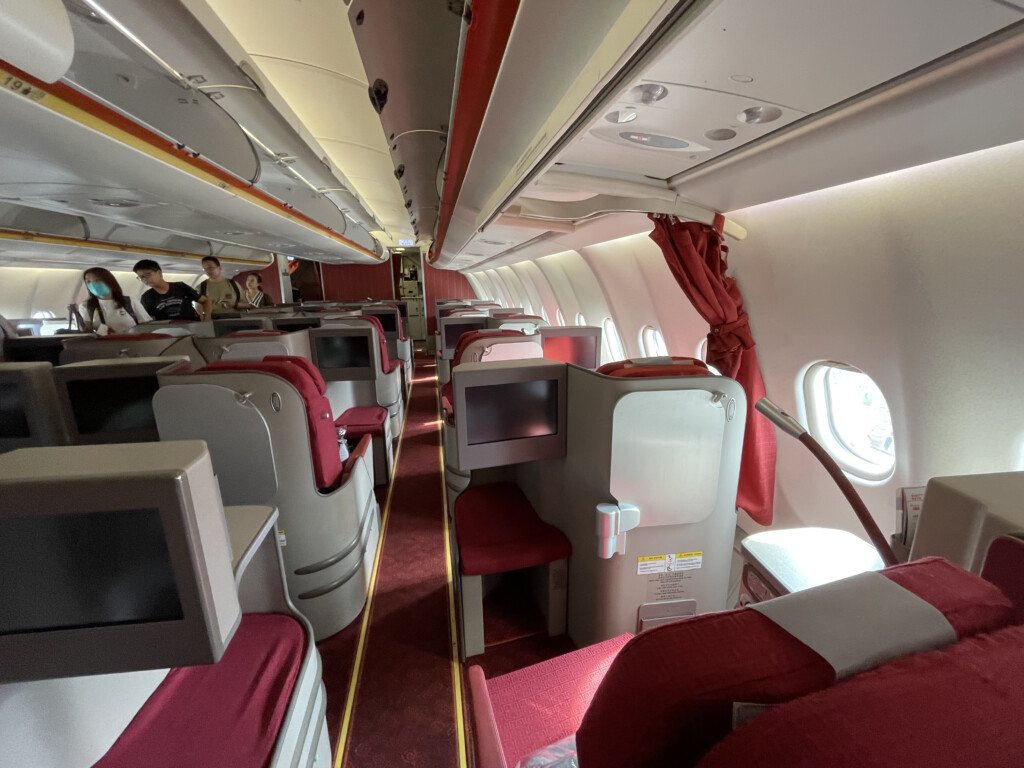 a plane with red seats and a tv