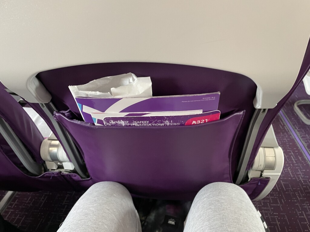 a purple seat with a magazine in it