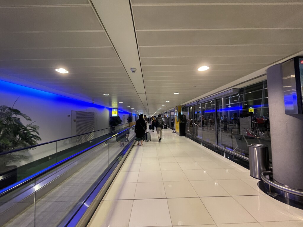people walking on an escalator in a airport
