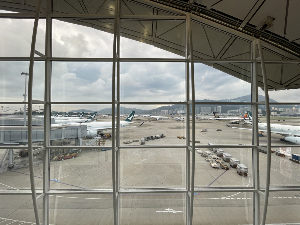 a large window with many airplanes in the airport