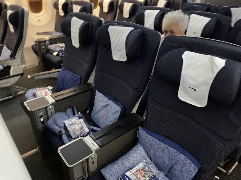 an airplane seat with a person sitting in it