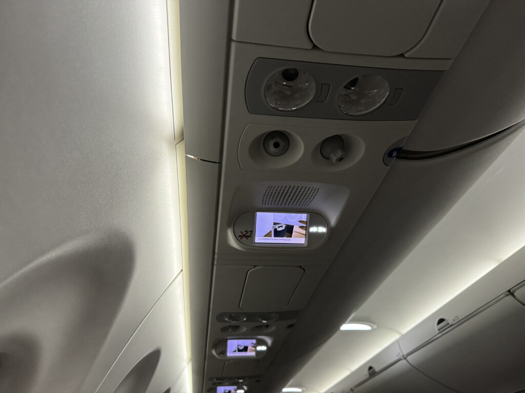 a overhead panel with a screen and a safety video