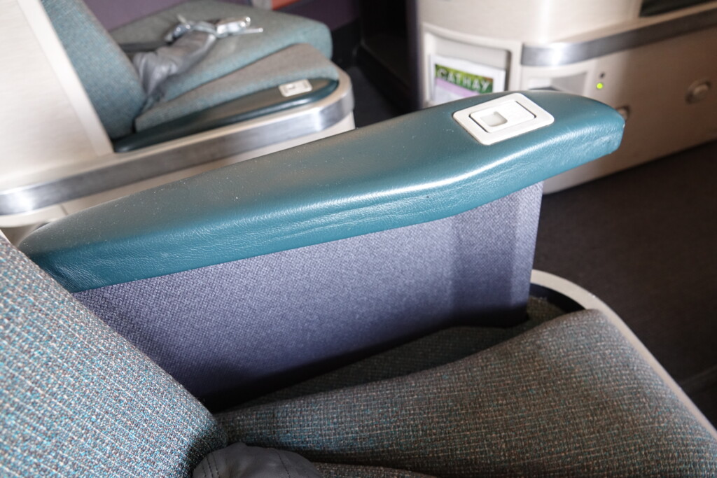 a seat arm rest in an airplane
