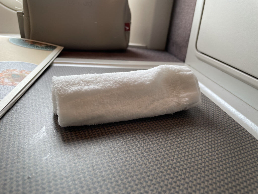 a white rolled up towel on a table