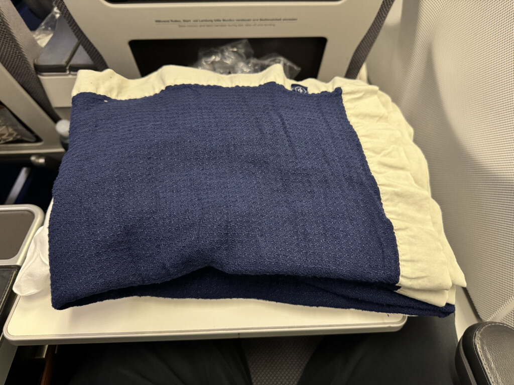 a blue and white blanket on a white surface
