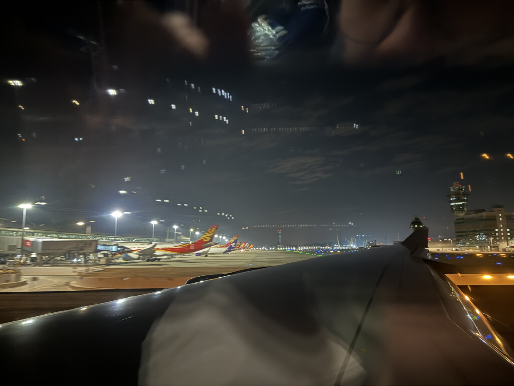 a view of airplanes at night from a window