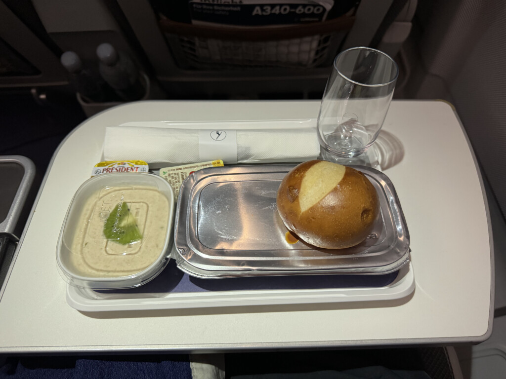 a tray with food and a glass on it