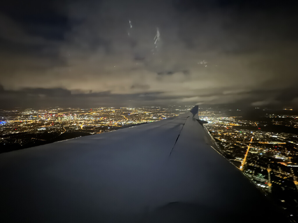 an wing of an airplane at night