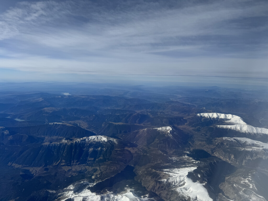 a aerial view of mountains and snow