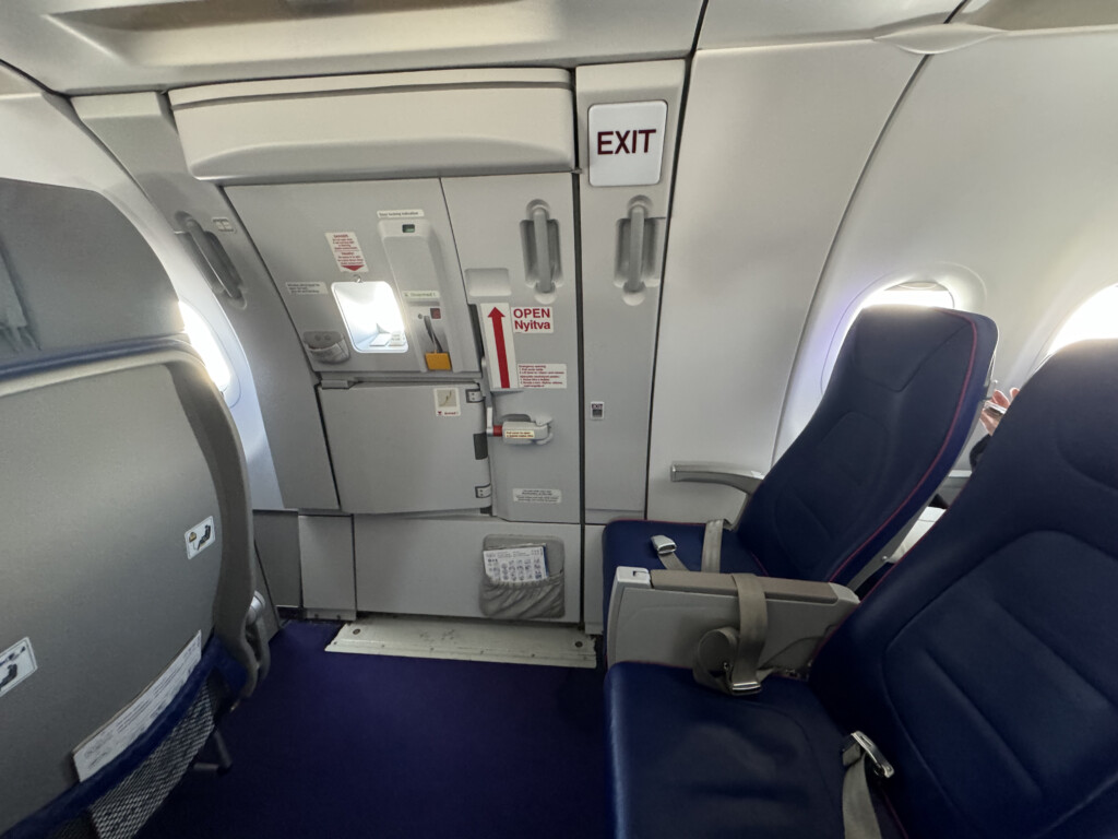 an airplane with blue seats and a door