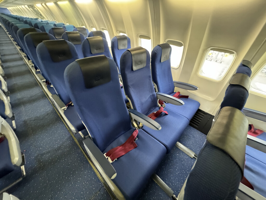a row of blue seats in an airplane