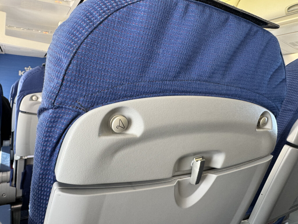 a seat with a blue fabric cover