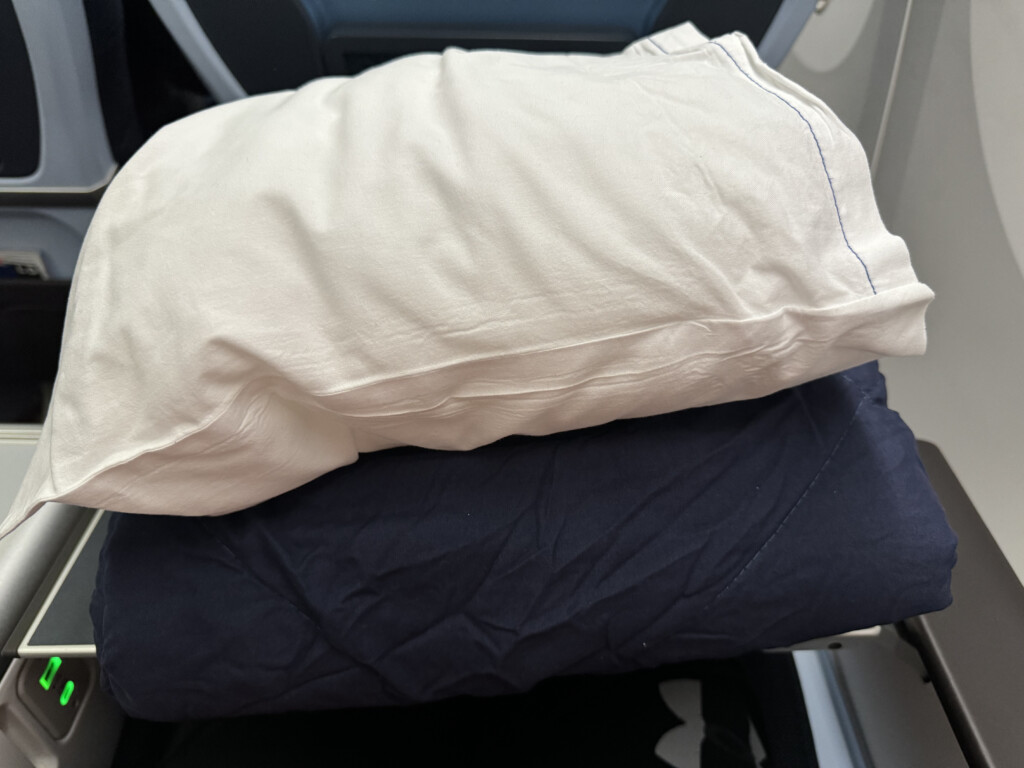 a white pillow on a blue and black pillow