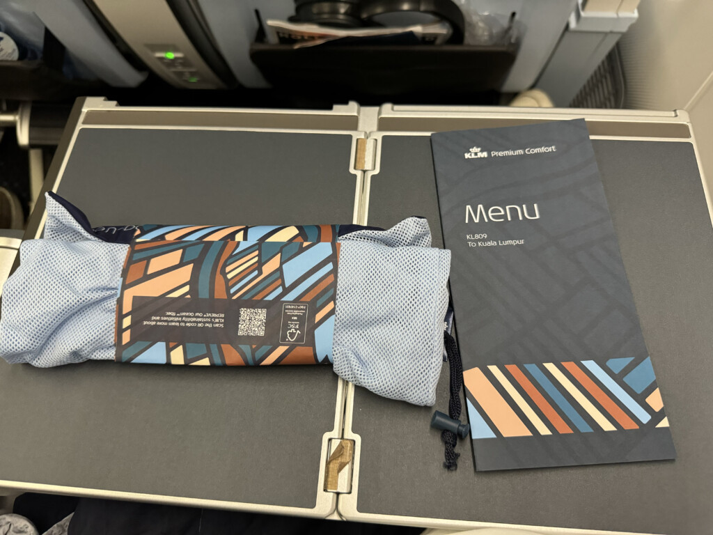 a blue and orange striped cloth in a package on a grey surface