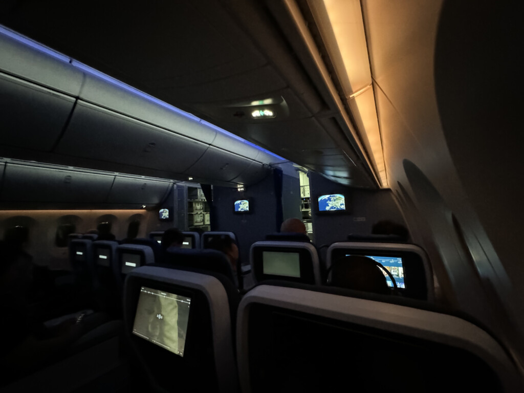 a seat on an airplane with a television screen