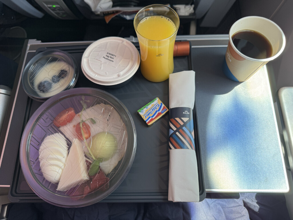 food on a tray with a drink and a napkin