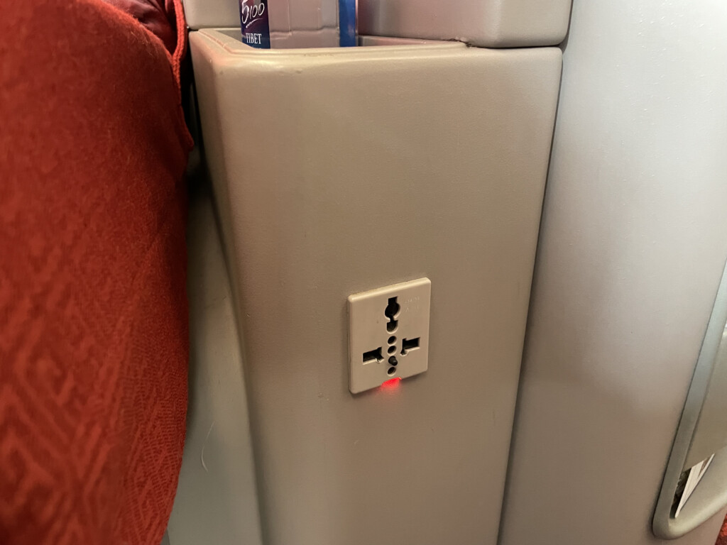 a plug in outlet with a red light