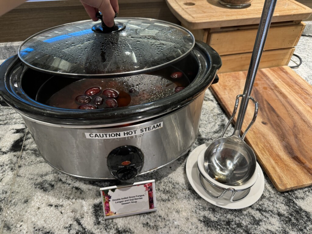 a crock pot with a lid and a spoon