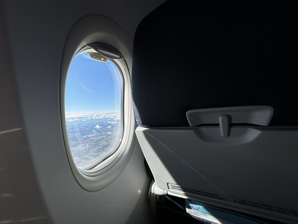 a window with a view of the sky and clouds